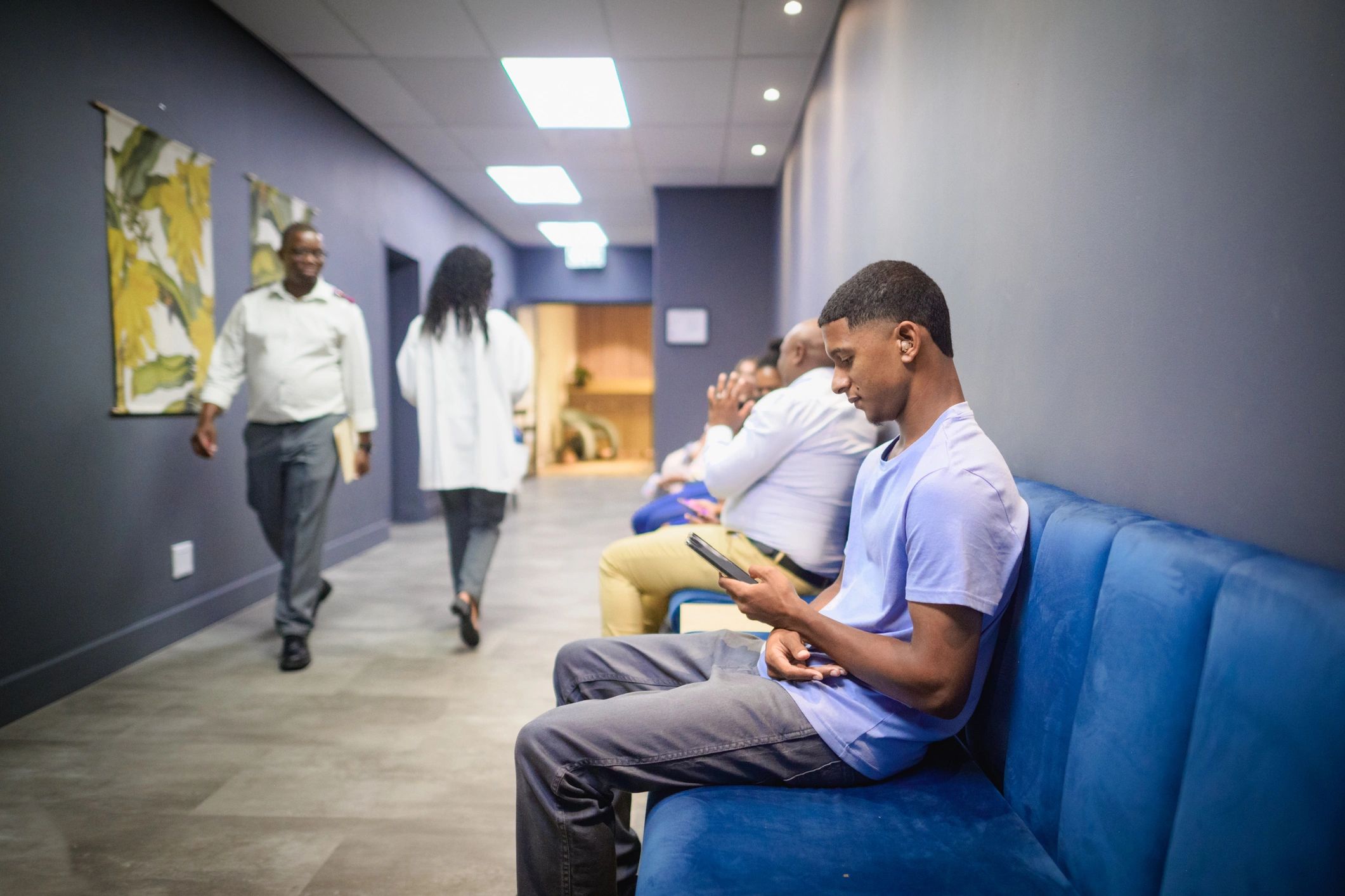Customer using a smartphone while waiting for assistance